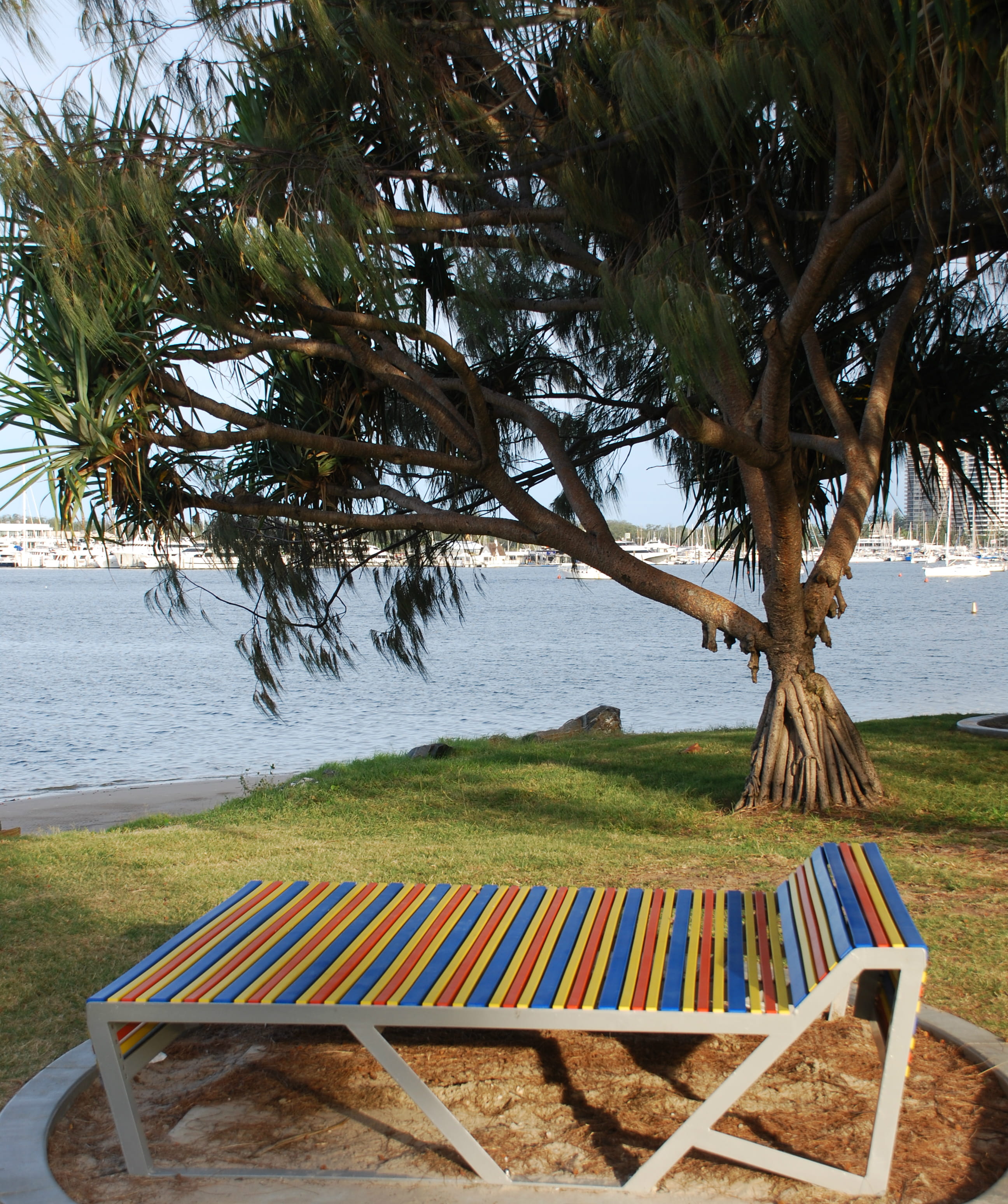 Touch of personality: Beach Towel themed day bed Southport Broadwater Parklands, Gold Coast. The custom furniture incorporating colourful plastic battens was manufactured by Street Furniture Australia.