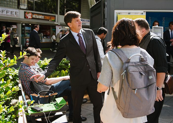 Assistant Minister for Cities Angus Taylor checks out PowerMe wifi charging tables at the official opening of Future Street. Photo: WE-EF.
