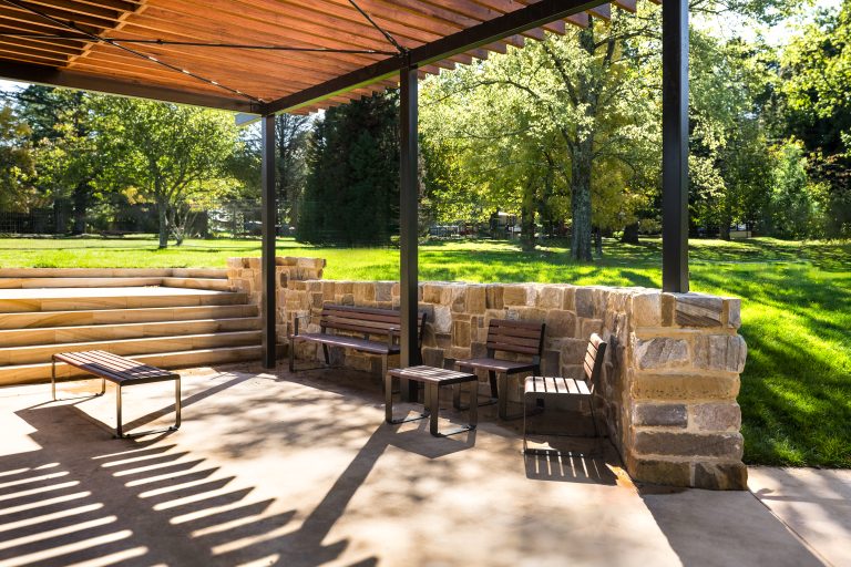 Linea Bench (LIB6) and Linea Seat (LIS10) with Spotted Gum hardwood battens, Textura Dark Bronze frame.