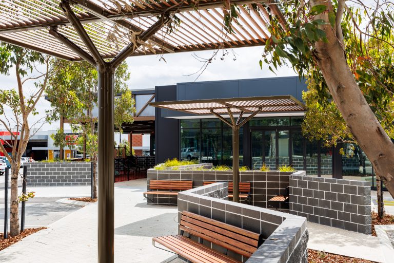 ChillOUT Tree with aluminium spotted gum louvres and duratec eternity bronze trunk, Linea wall mounted seats in aluminium spotted gum and charcoal frame
