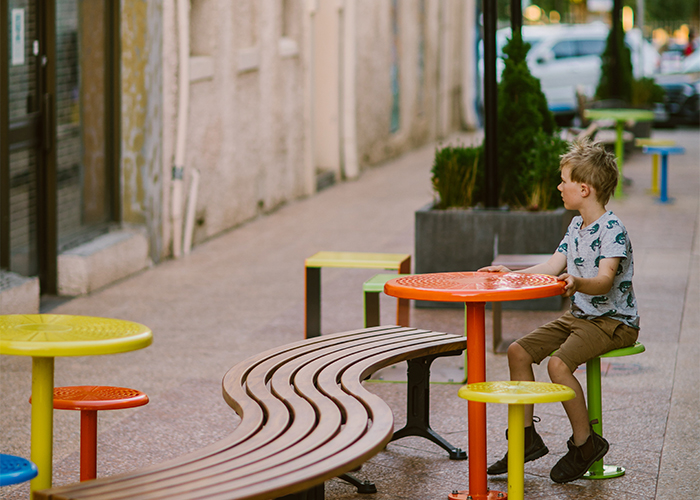 Mall Curved Slim Bench (CMM8-C) with aluminium Spotted Gum battens, Textura Monument frame. With Cafe Macchiato Table and Stool in Brilliant Yellow, Sensation Orange, Lycra Strip Green.