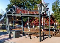 Park DDA Setting with side access, battens in aluminium woodgrain Spotted Gum, frames in Monument.