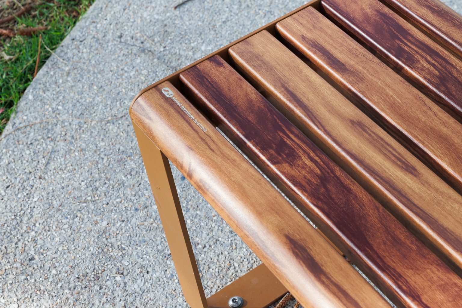 Linea Seat, 1800mm, with arms, aluminium woodgrain Spotted Gum battens, Textura Russet frames.