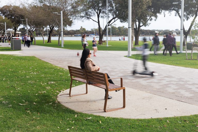 Linea Seat, 1800mm, with arms, aluminium woodgrain Spotted Gum battens, Textura Russet frames.
