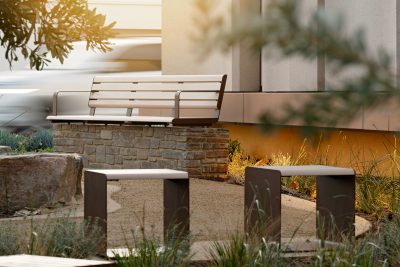 Linea Seat (2100mm, plinth-fixed, arms) and Cube, aluminium Curly Birch battens, Textura Core Ten frames.