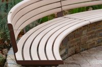 Linea Curved Seat (tailored radius, plinth-fixed) with aluminium Curly Birch battens and Textura Core Ten frames.