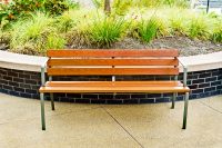 Forum Seat (3-seater) in aluminium woodgrain Bush Cherry, with Woodland Grey frames.