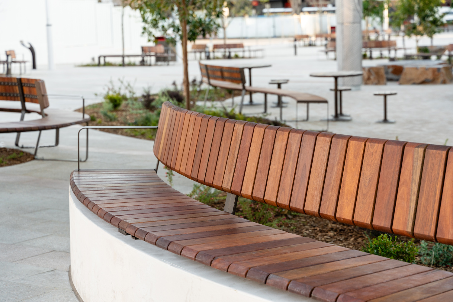 Linea VT Curved Seat (LVS10-C) convex, plinth-fixed with hardwood battens, Textura Dark Bronze frame.
