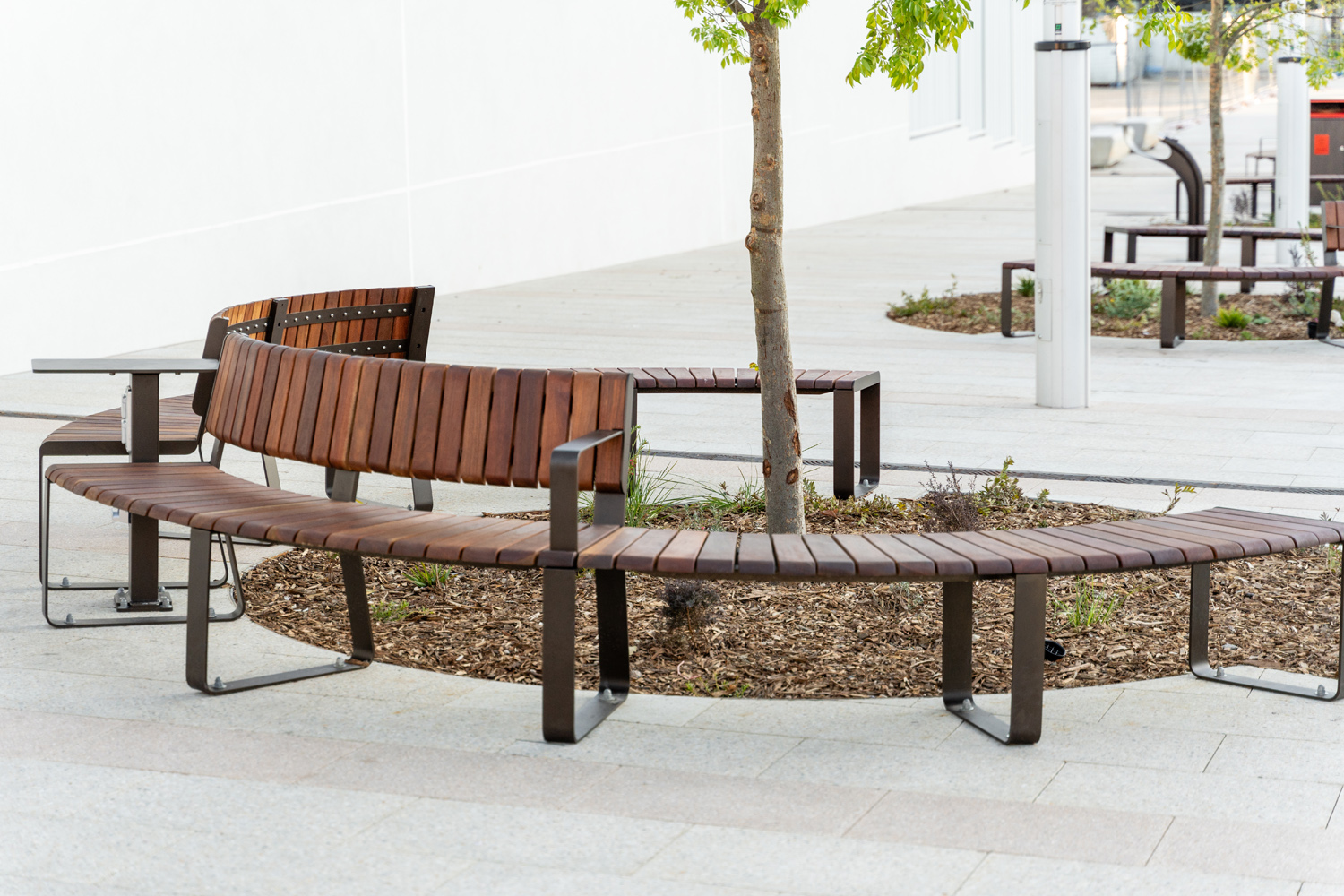 Linea VT Curved Seat (LVS10-C) and Bench (LVB6-C) with hardwood battens, Textura Dark Bronze frame.
