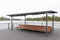 Classic Plaza Back-to-Back Seat with aluminium woodgrain battens in Spotted Gum, Sable Bass frame.