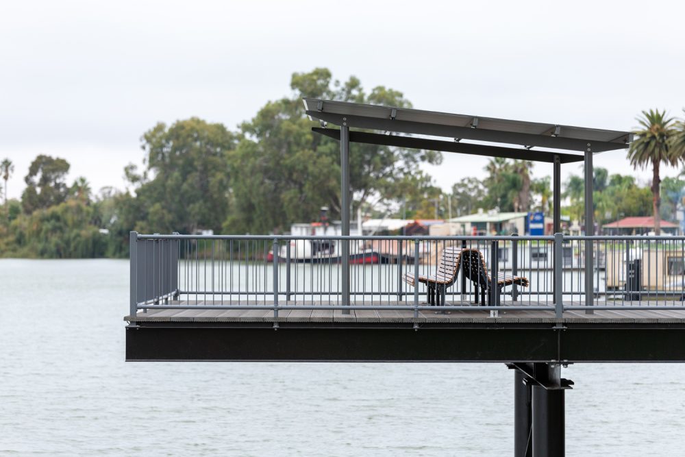 Classic Plaza Back-to-Back Seat with aluminium woodgrain battens in Spotted Gum, Sable Bass frame.