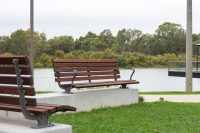 Plinth-mounted Mall DDA Seats with Jarrah battens and frames in tailored colour Metropolis Storm Pearl grey.