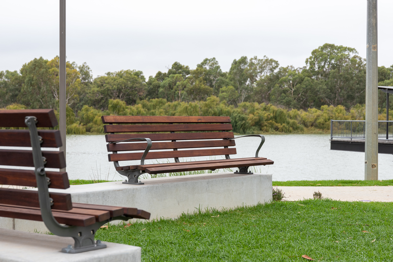Plinth-mounted Mall DDA Seats with Jarrah battens and frames in tailored colour Metropolis Storm Pearl grey.