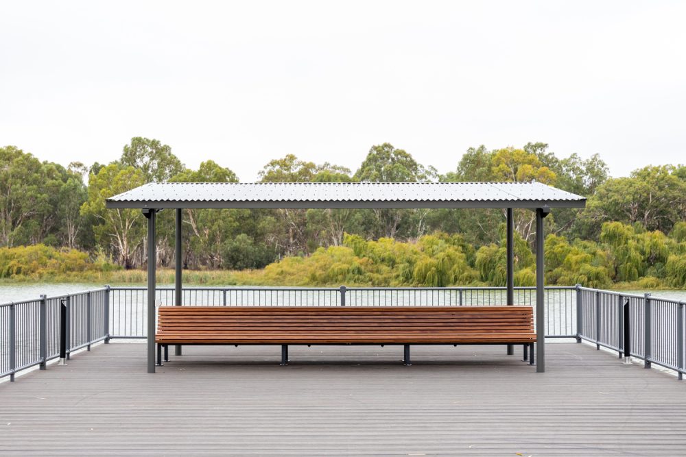 Classic Plaza Back-to-Back Seat with aluminium woodgrain battens in Spotted Gum, Sable Bass frame.