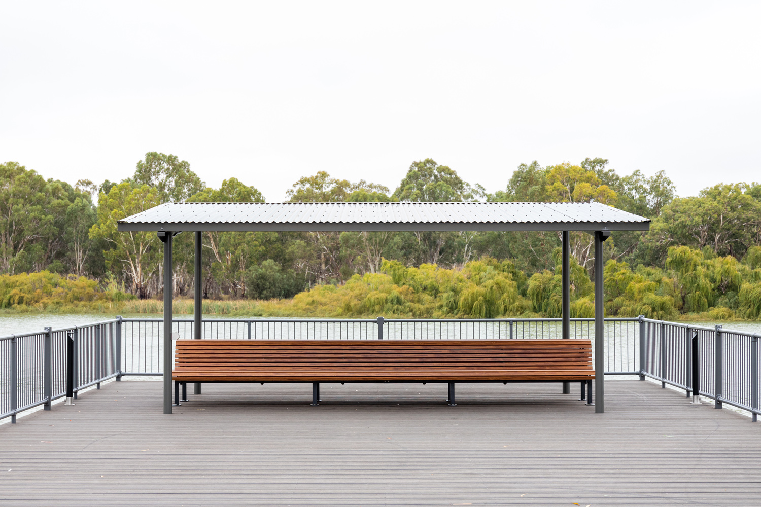 Classic Plaza Back-to-Back Seat with aluminium woodgrain battens in Spotted Gum, Sable Bass frame.