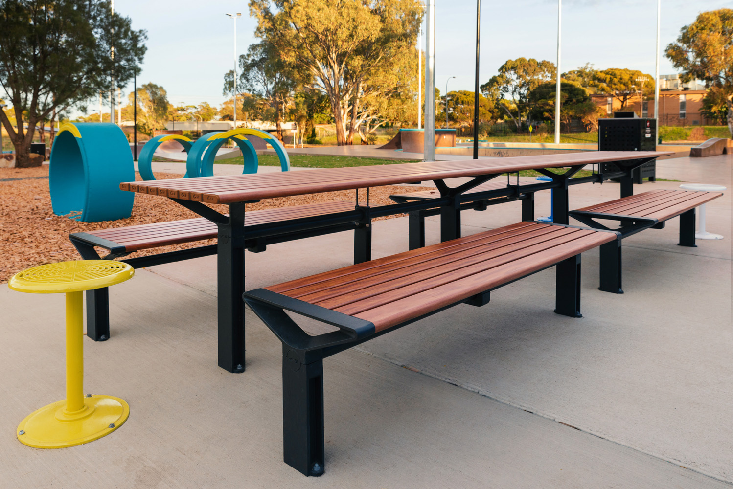 Aria Long Communal Table (CMA6-L) with aluminium Spotted Gum battens, Textura Monument frames.