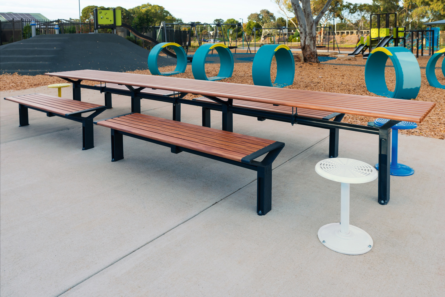 Aria Long Communal Table (CMA6-L) with aluminium Spotted Gum battens, Textura Monument frames.