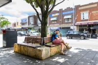 Linea Seat (LIS10, 1500mm) plinth-fixed with aluminium woodgrain Bush Cherry battens, Monument frame.