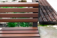 Linea Seat (LIS10, 1500mm) plinth-fixed with aluminium woodgrain Bush Cherry battens, Monument frame.