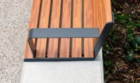 Linea Seat (LIS10) 1800mm with aluminium woodgrain Spotted Gum battens, Monument frame, plinth-fixed.