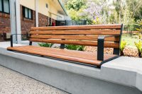 Linea Seat (LIS10) 1800mm with aluminium woodgrain Spotted Gum battens, Monument frame, plinth-fixed.