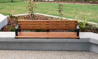 Linea Seat (LIS10) 1800mm with aluminium woodgrain Spotted Gum battens, Monument frame, plinth-fixed.