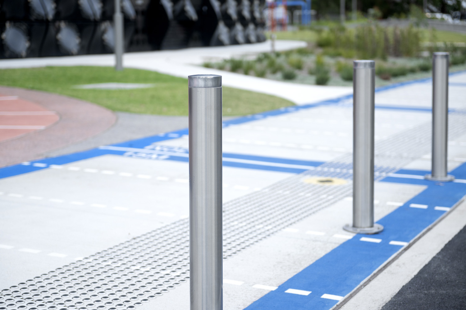 Slim Bollard (B5-F) in stainless steel 304, No.4 finish (brushed) with flat polished top.