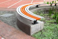 Mall Curved Slim Bench (CMM8-C) plinth-fixed, Textura Silver and Sensation Orange battens, Charcoal frame.