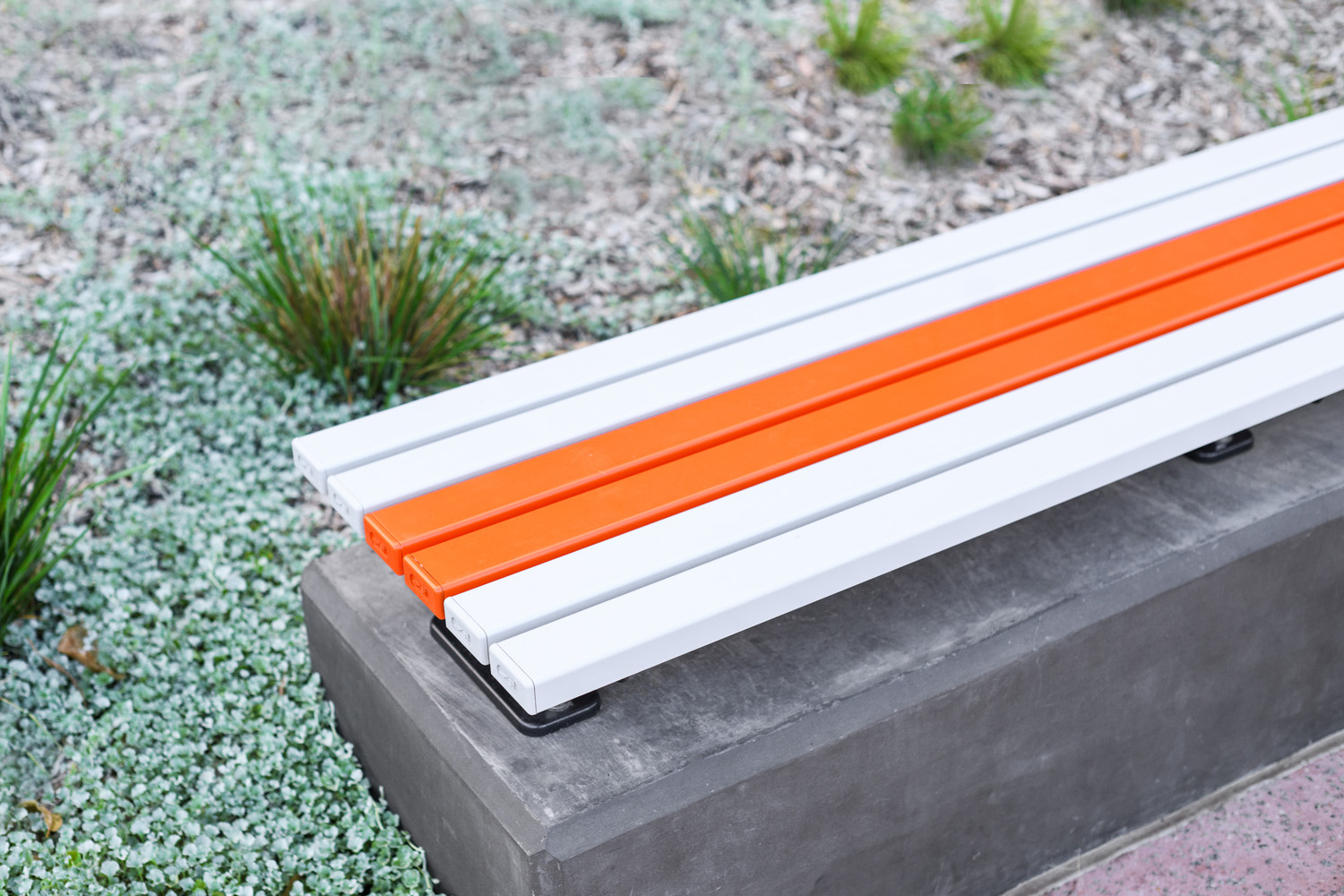 Mall Slim Bench (CMM8) plinth-fixed with Textura Silver and Sensation Orange battens, Charcoal frame.