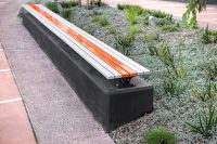 Mall Slim Bench (CMM8) plinth-fixed with Textura Silver and Sensation Orange battens, Charcoal frame.