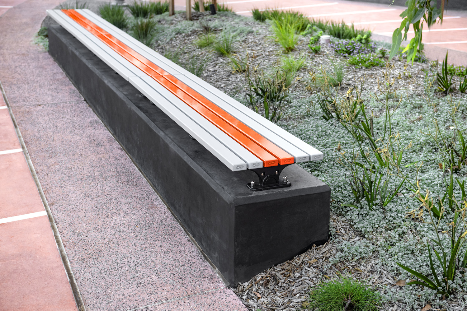 Mall Slim Bench (CMM8) plinth-fixed with Textura Silver and Sensation Orange battens, Charcoal frame.