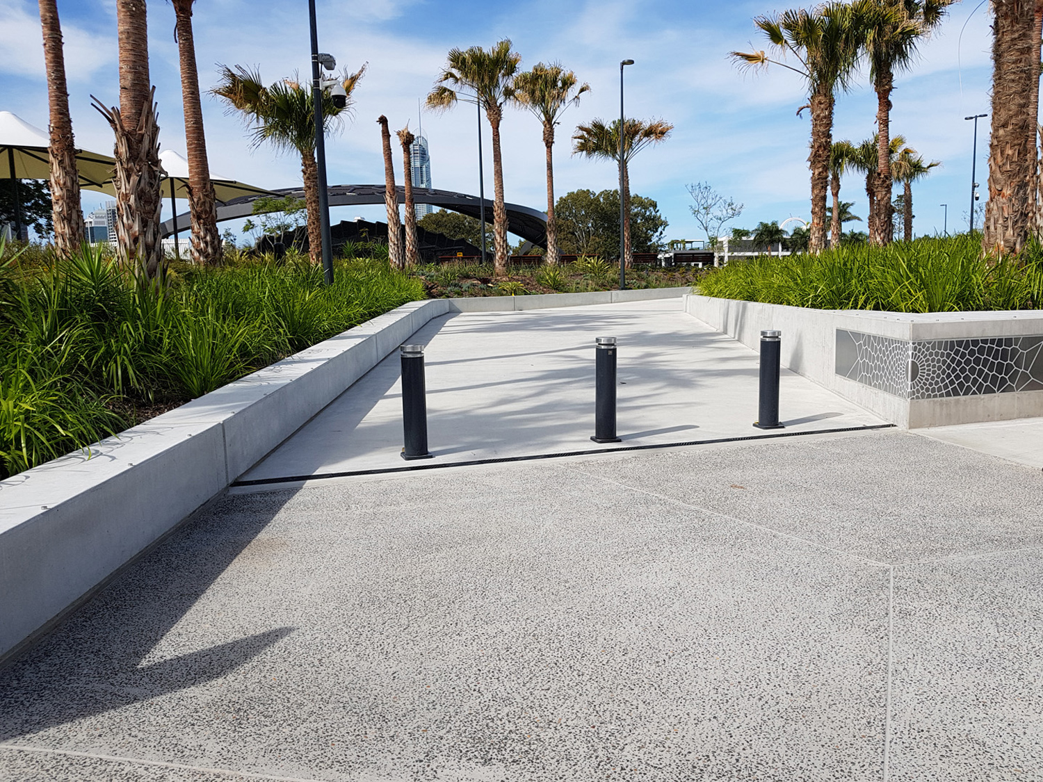 Wide Bollards protect pedestrians traversing from the carpark to amphitheatre, through green space.