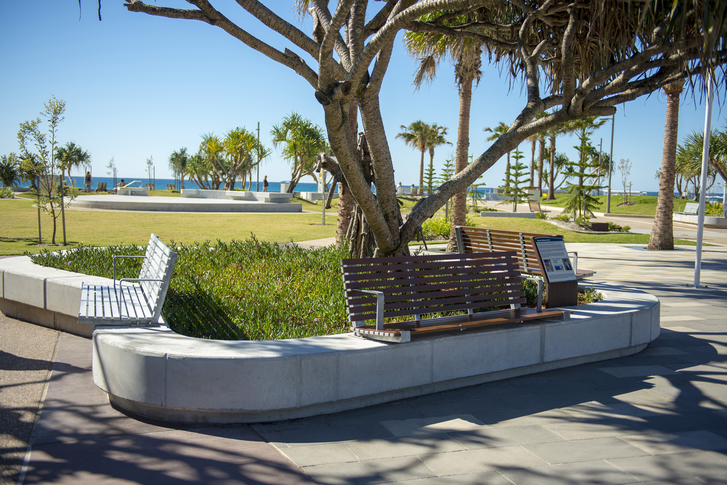 Custom seats on concrete plinths with aluminium woodgrain Woodland Grey battens.