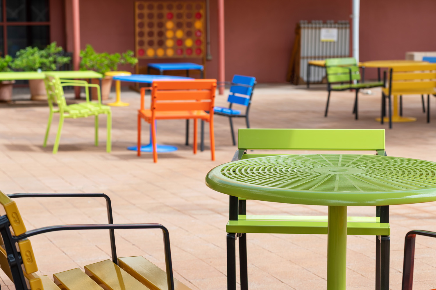 Cafe Round Table and Forum Seats in Lycra Strip, Sunshine, Sensation Orange and Bondi Blue.