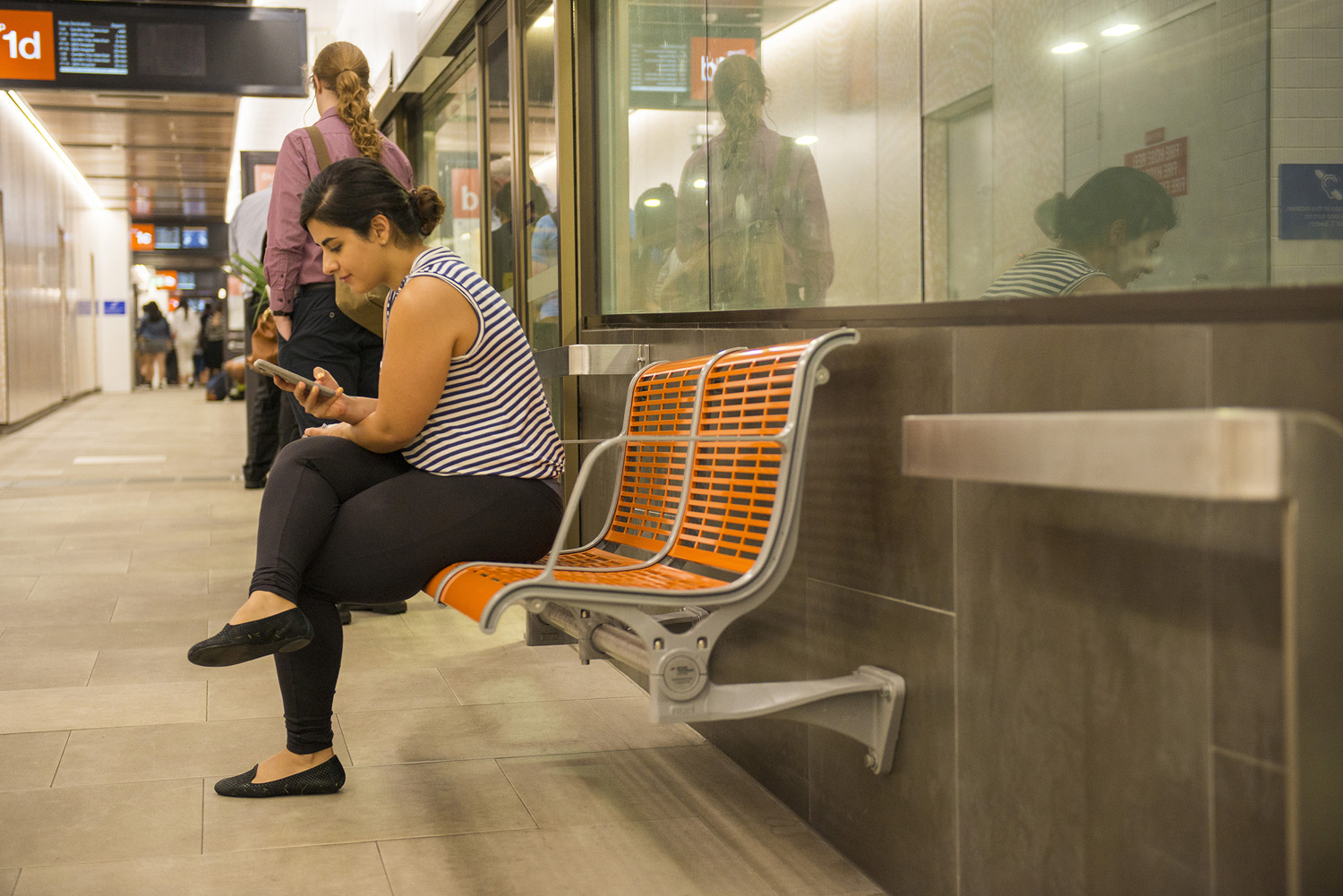 TransLink's bright orange Concourse Seats add warmth and comfort to the refurbished station.