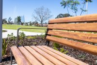 Linea Seat (LIS10, 1800mm) with aluminium woodgrain Spotted Gum battens, Textura Dark Bronze frame.