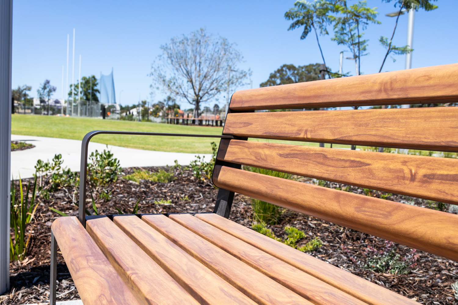 Linea Seat (LIS10, 1800mm) with aluminium woodgrain Spotted Gum battens, Textura Dark Bronze frame.