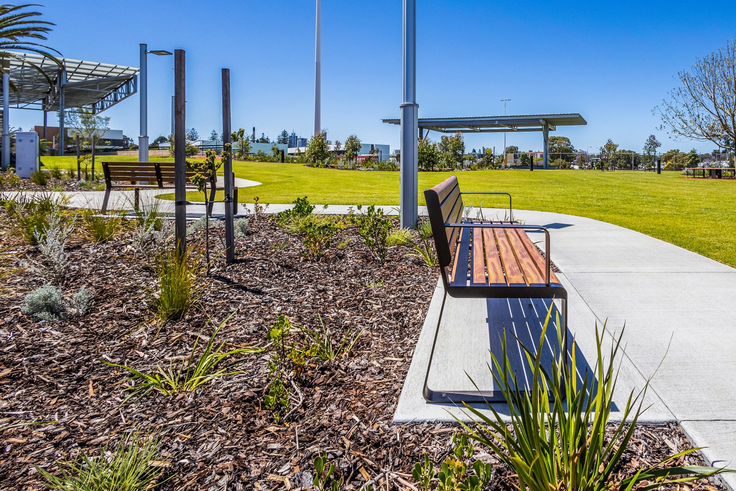 Linea Seat (LIS10, 1800mm) with aluminium woodgrain Spotted Gum battens, Textura Dark Bronze frame.