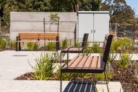 Linea Seat (LIS10, 1800mm) with aluminium woodgrain Spotted Gum battens, Textura Dark Bronze frame.