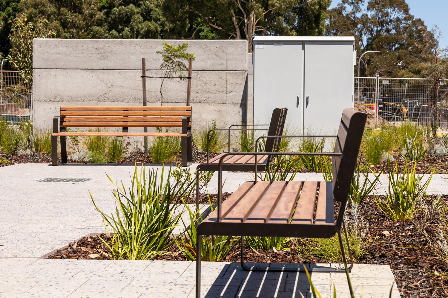 Linea Seat (LIS10, 1800mm) with aluminium woodgrain Spotted Gum battens, Textura Dark Bronze frame.