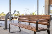 Linea Seat (LIS10, 1800mm) with aluminium woodgrain Spotted Gum battens, Textura Dark Bronze frame.