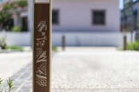 Linea Bollard (B6) with etched artwork, aluminium Bush Cherry insert, Textura Doe Skin frame.