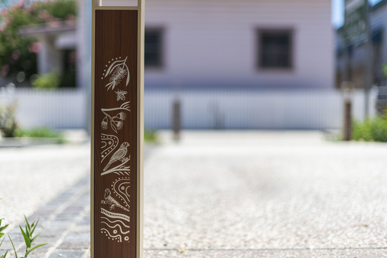 Linea Bollard (B6) with etched artwork, aluminium Bush Cherry insert, Textura Doe Skin frame.