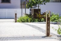 Linea Bollard (B6) with etched artwork, aluminium Bush Cherry insert, Textura Doe Skin frame.