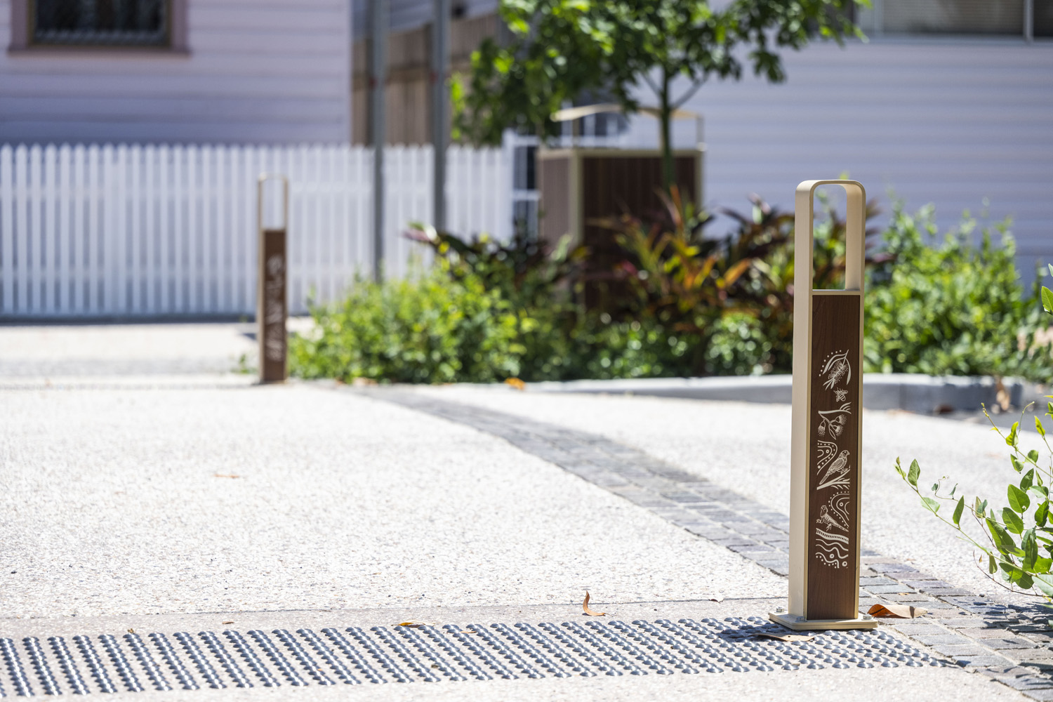 Linea Bollard (B6) with etched artwork, aluminium Bush Cherry insert, Textura Doe Skin frame.