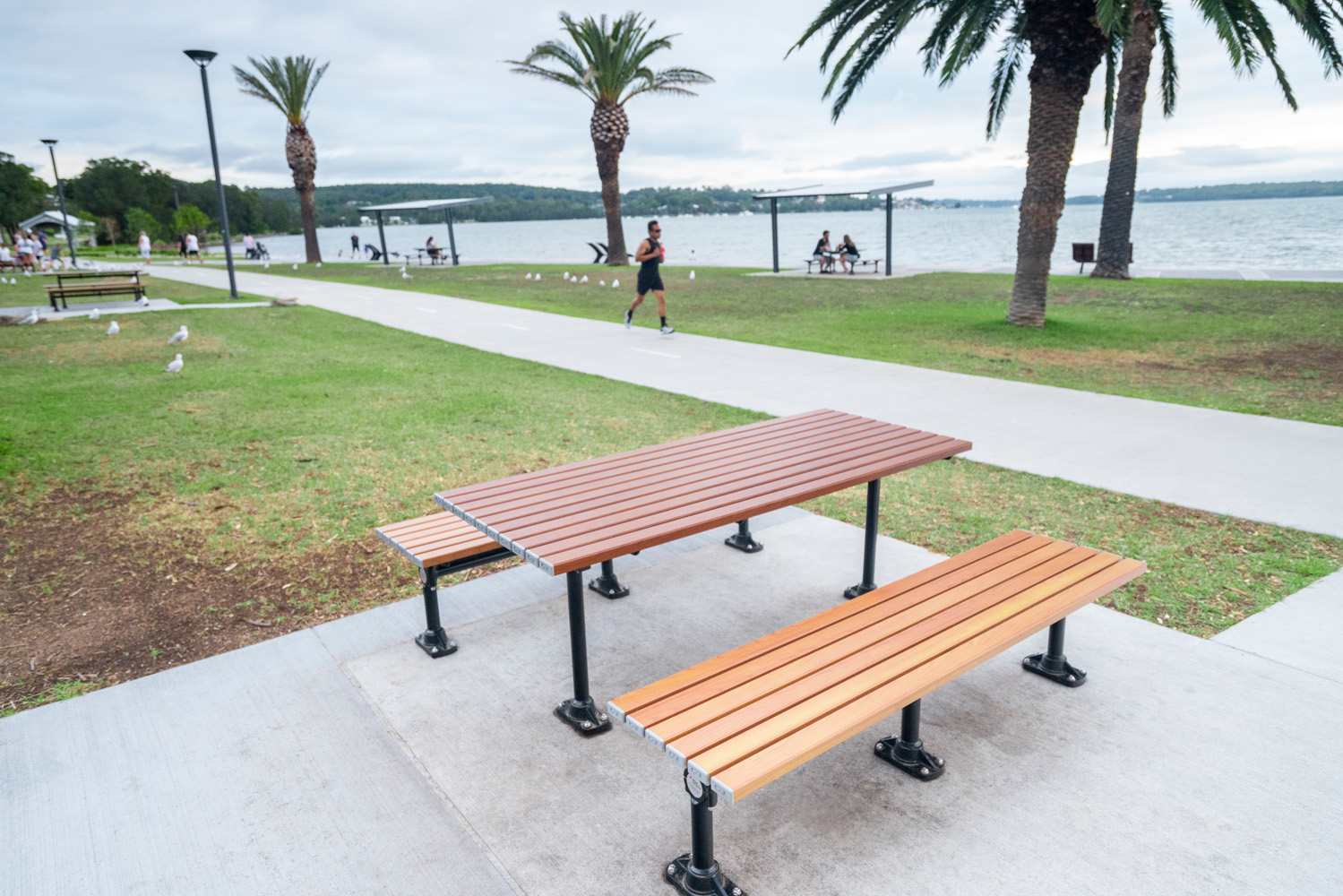 Mall Table with battens in woodgrain aluminium Bush Cherry, Mall Slim Benches with tailored woodgrain battens.
