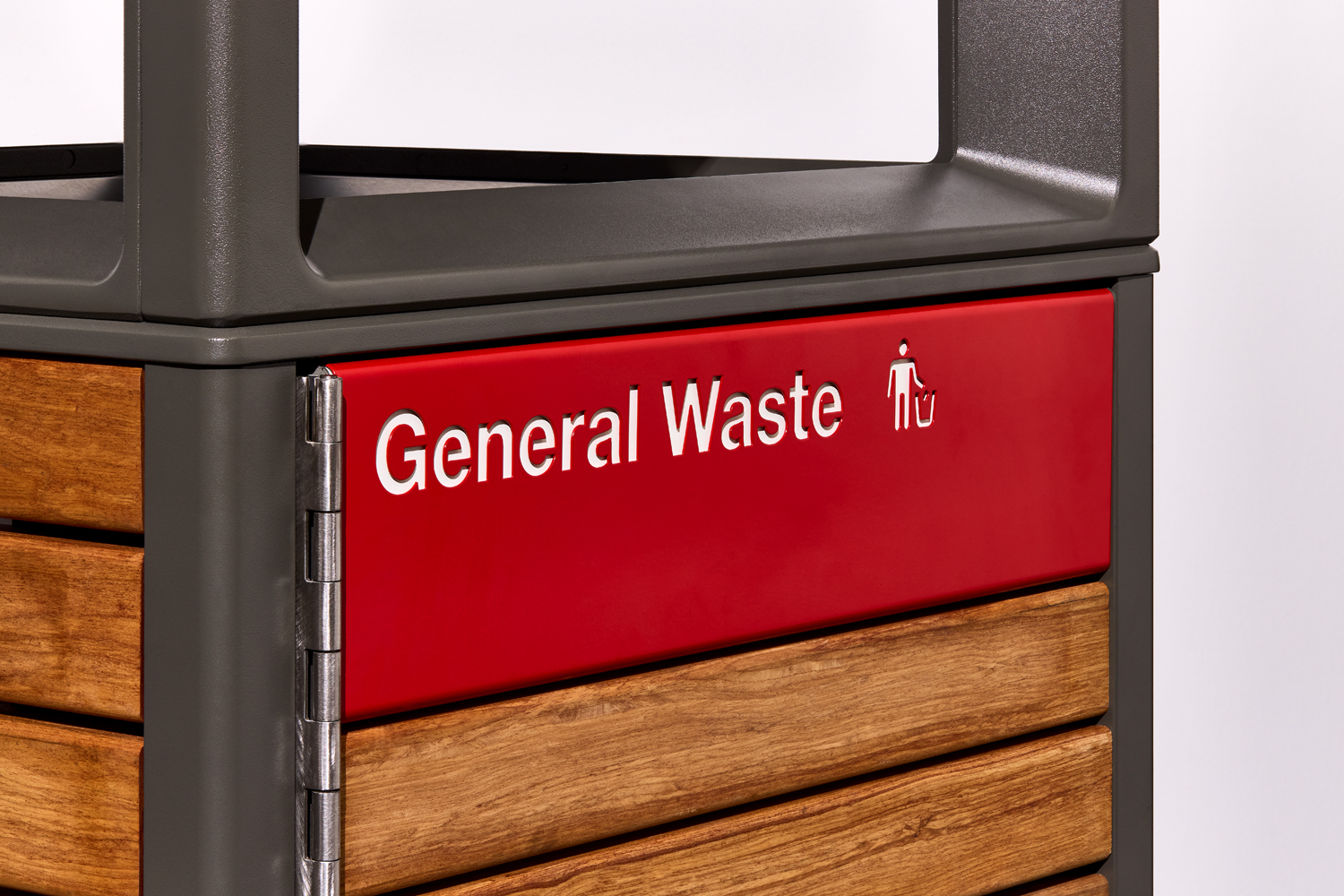 Red panel on a waste bin labeled 'General Waste' with a user-icon, part of a metal-and-wood sorting unit.